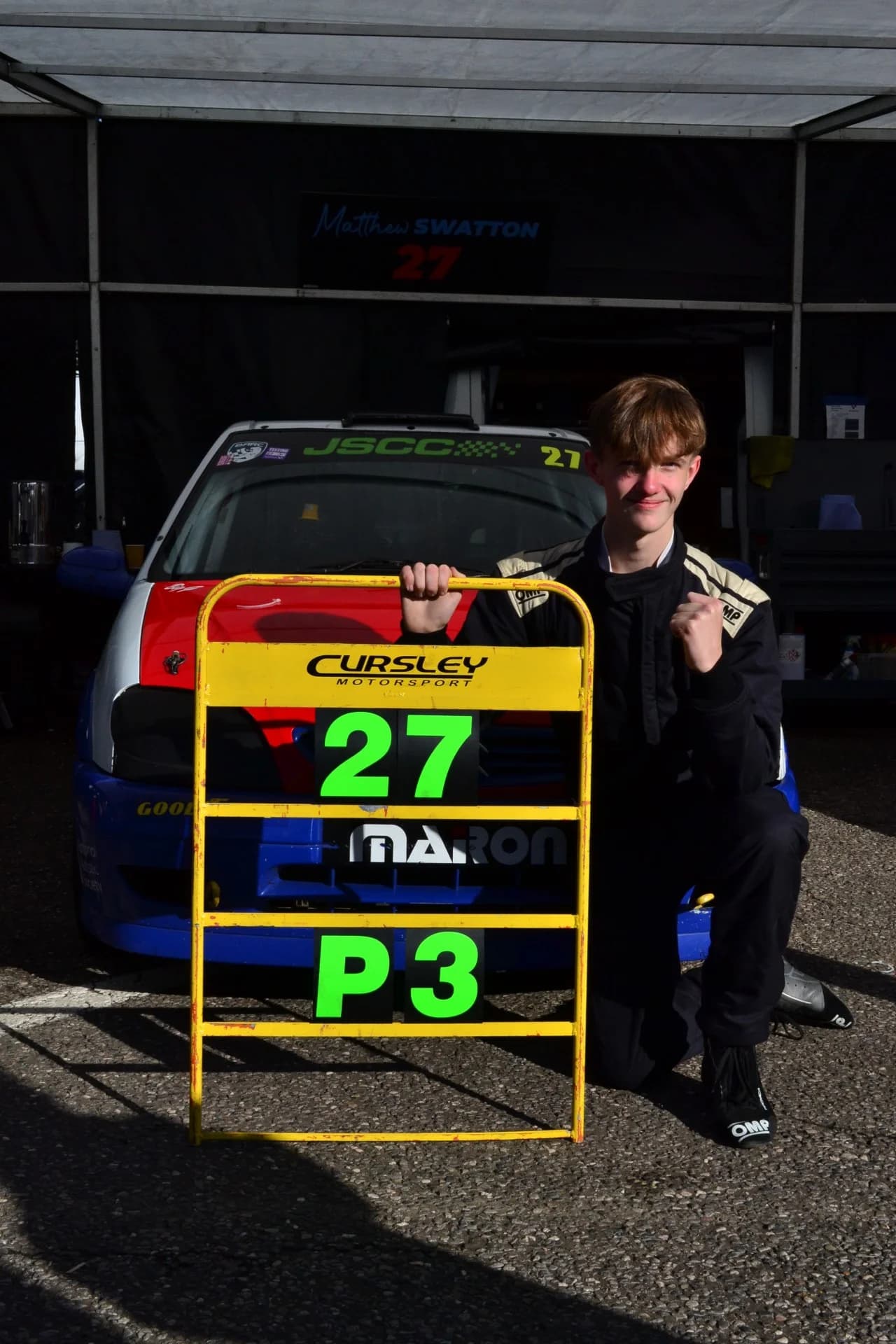Matthew Swatton proudly holding his pit sign showing his P3 in the 2025 JSCC rookie championship